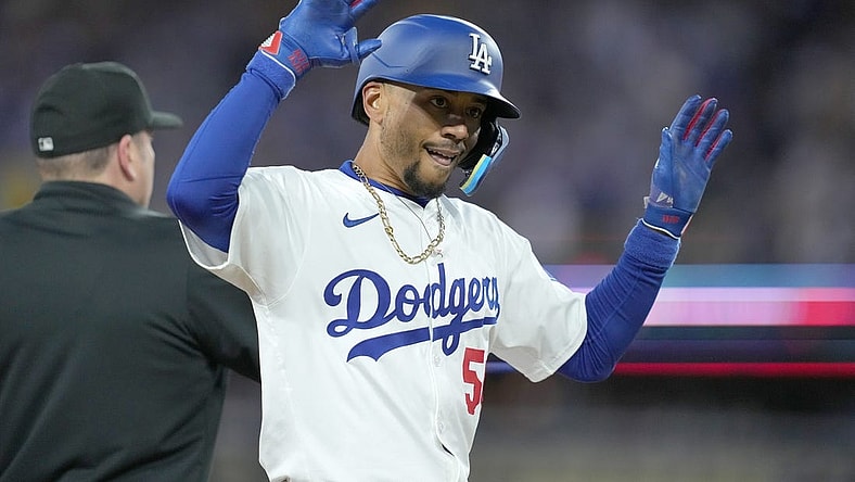Apr 1, 2024; Los Angeles, California, USA; Los Angeles Dodgers shortstop Mookie Betts (50) reacts after hitting a triple in the first inning against the San Francisco Giants at Dodger Stadium. Mandatory Credit: Kirby Lee-USA TODAY Sports