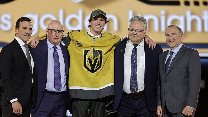 Trevor Connelly, center, poses after being selected by the Vegas Golden Knights during the first round of the NHL hockey draft Friday, June 28, 2024, in Las Vegas. (AP Photo/Steve Marcus)