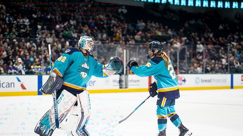 New York Sirens goalie Kayle Osborne fist bumps rookie forward Casey O'Brien.
