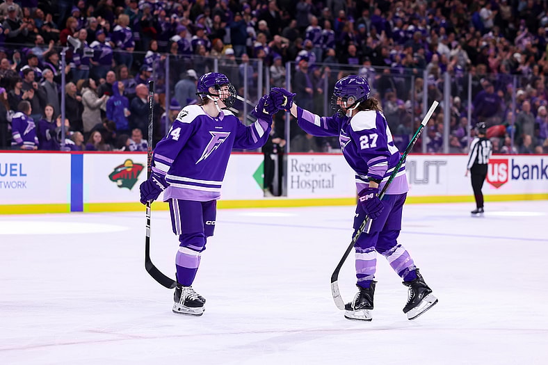 Minnesota Frost forwards Taylor Heise and Abby Hustler celebrate after a goal.