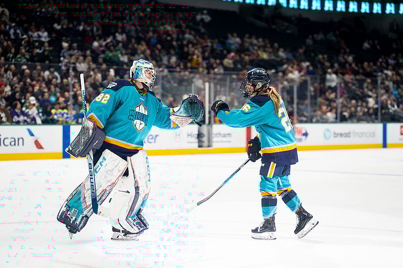 New York Sirens goalie Kayle Osborne fist bumps rookie Casey O'Brien after her hat trick.