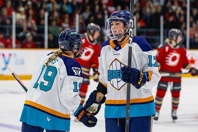 New York Sirens forward Taylor Girard high-fives Paetyn Levis.