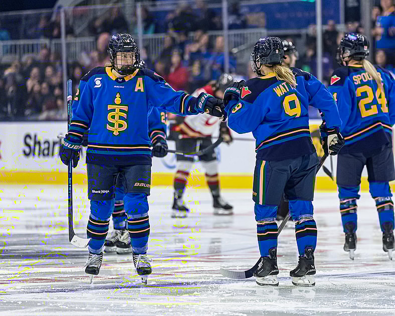Toronto Sceptres skaters Allie Munroe and Daryl Watts bump fists.