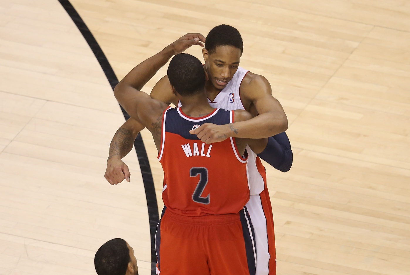 John Wall and DeMar DeRozan congratulate each other after withstanding a triple-overtime game. Photo via Tom Szczerbowski