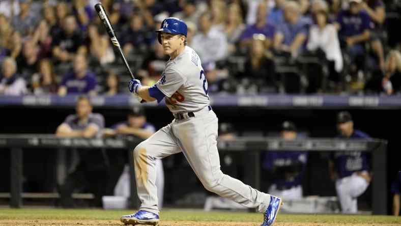 Sep 25, 2015; Denver, CO, USA; Los Angeles Dodgers third baseman Chase Utley (26) doubles in the fifth inning against the Colorado Rockies at Coors Field. Mandatory Credit: Ron Chenoy-USA TODAY Sports