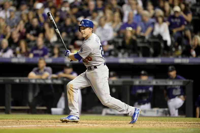Sep 25, 2015; Denver, CO, USA; Los Angeles Dodgers third baseman Chase Utley (26) doubles in the fifth inning against the Colorado Rockies at Coors Field. Mandatory Credit: Ron Chenoy-USA TODAY Sports