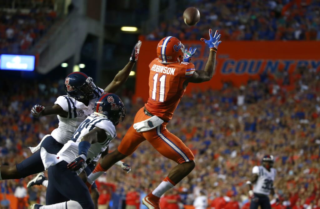 Oct 3, 2015; Gainesville, FL, USA; Florida Gators wide receiver Demarcus Robinson (11) catches the ball for a touchdown over Mississippi Rebels defensive back Mike Hilton (38) during the first quarter at Ben Hill Griffin Stadium. Mandatory Credit: Kim Klement-USA TODAY Sports