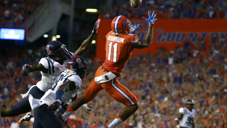 Oct 3, 2015; Gainesville, FL, USA; Florida Gators wide receiver Demarcus Robinson (11) catches the ball for a touchdown over Mississippi Rebels defensive back Mike Hilton (38) during the first quarter at Ben Hill Griffin Stadium. Mandatory Credit: Kim Klement-USA TODAY Sports