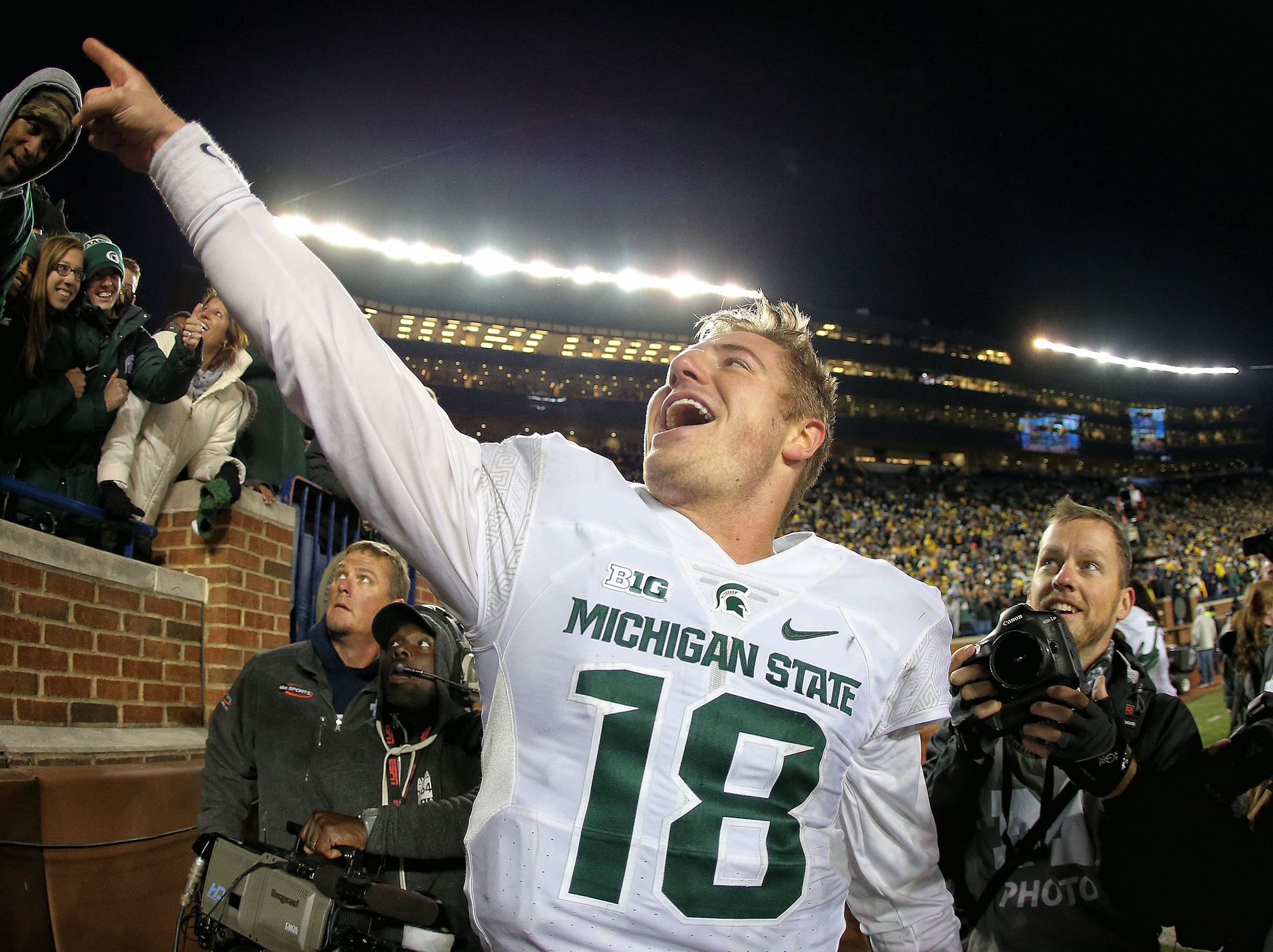 Oct 17, 2015; Ann Arbor, MI, USA; Michigan State Spartans quarterback Connor Cook (18) celebrates a win over the Michigan Wolverines during the second half of a game at Michigan Stadium. Mandatory Credit: Mike Carter-USA TODAY Sports