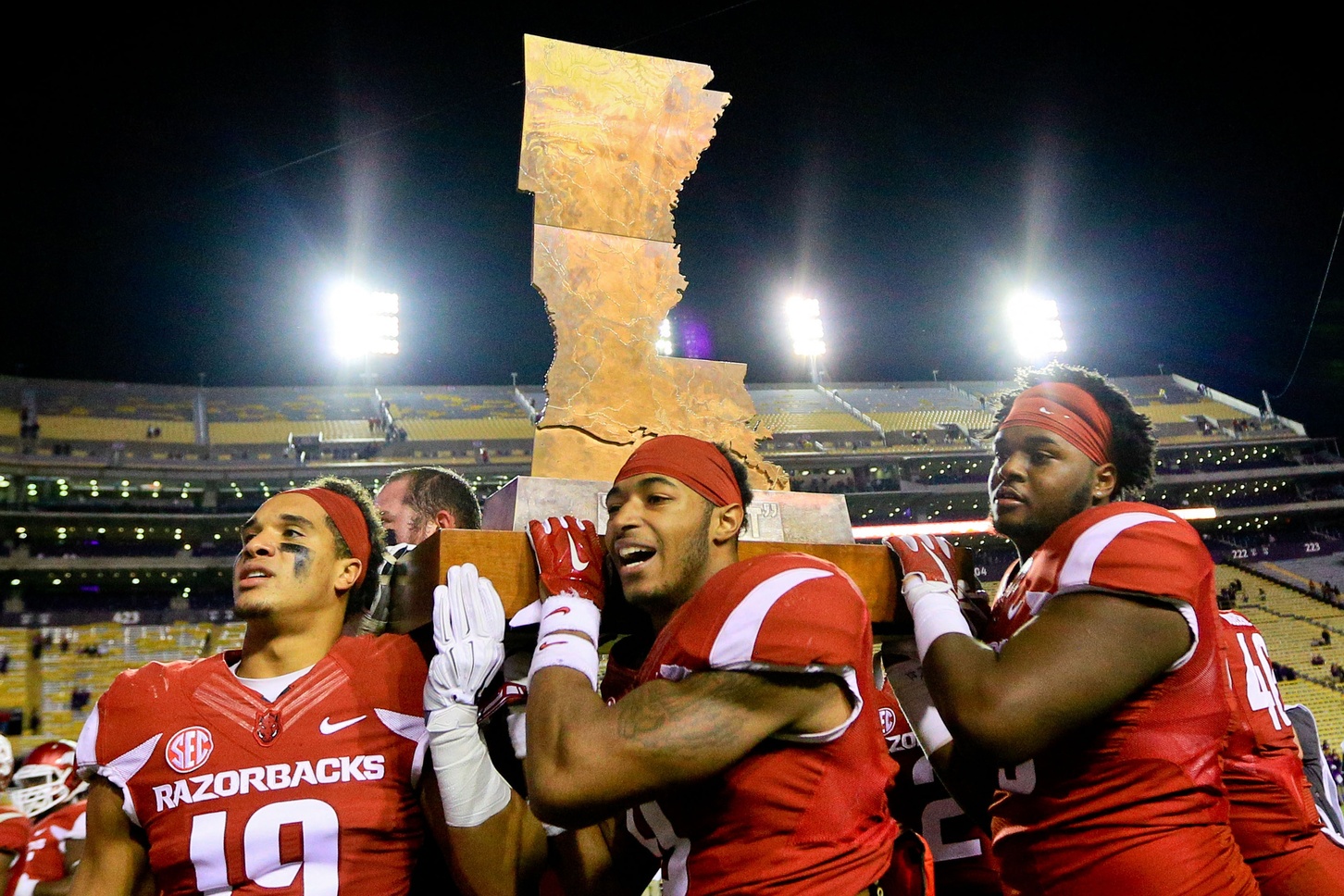 Nov 14, 2015; Baton Rouge, LA, USA; The Arkansas Razorbacks players carry The Boot trophy after defeating the LSU Tigers 31-14 at Tiger Stadium. Mandatory Credit: Derick E. Hingle-USA TODAY Sports