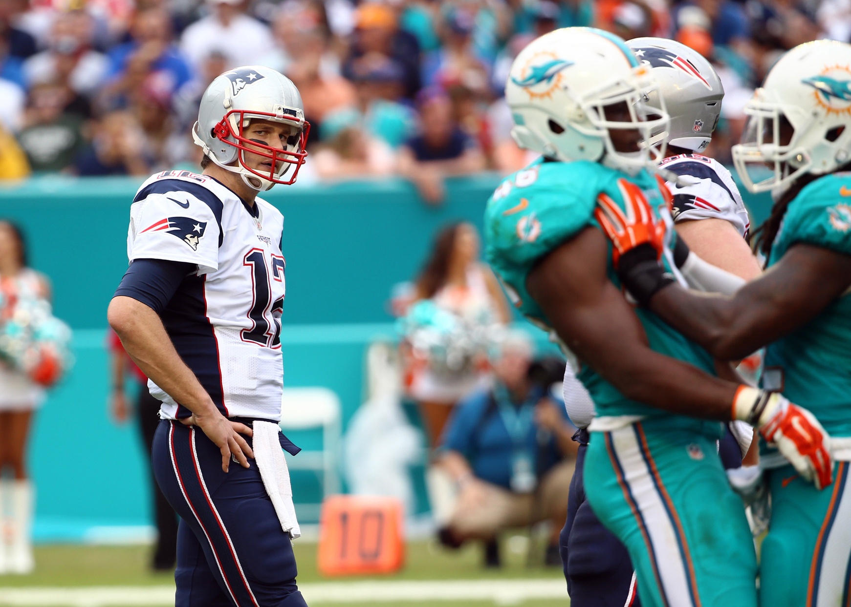 Jan 3, 2016; Miami Gardens, FL, USA; New England Patriots quarterback Tom Brady (12) looks over at members of the Miami Dolphins during the second half at Sun Life Stadium. The Dolphins won 20-10. Mandatory Credit: Steve Mitchell-USA TODAY Sports