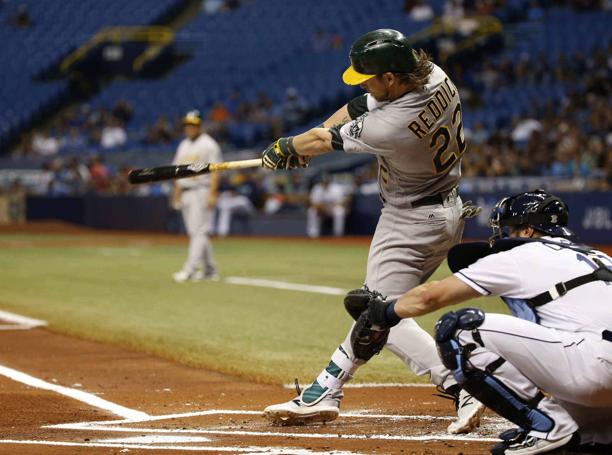 May 13, 2016; St. Petersburg, FL, USA; Oakland Athletics right fielder Josh Reddick (22) singles during the first inning against the Tampa Bay Rays at Tropicana Field. Mandatory Credit: Kim Klement-USA TODAY Sports 
