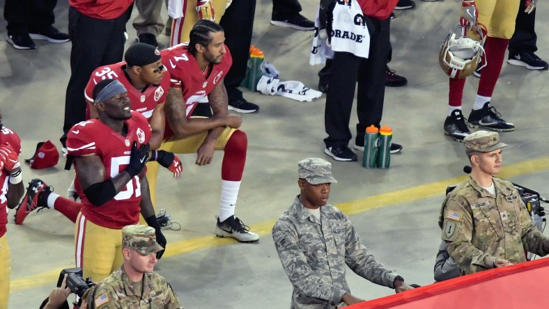 Eric Reid and Colin Kaepernick kneel during the anthem