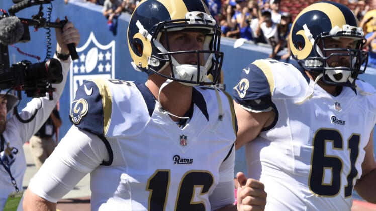 Rams quarterback Jared Goff leads the team on the field