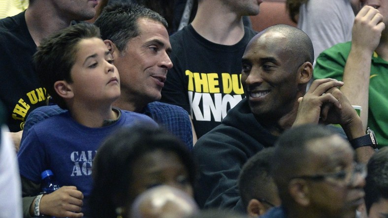 Caption: March 26, 2016; Anaheim, CA, USA; Los Angeles Lakers player Kobe Bryant with agent Rob Pelinka in attendance as the Oregon Ducks play against Oklahoma Sooners during the second half of the West regional final of the NCAA Tournament at Honda Center. Mandatory Credit: Richard Mackson-USA TODAY Sports