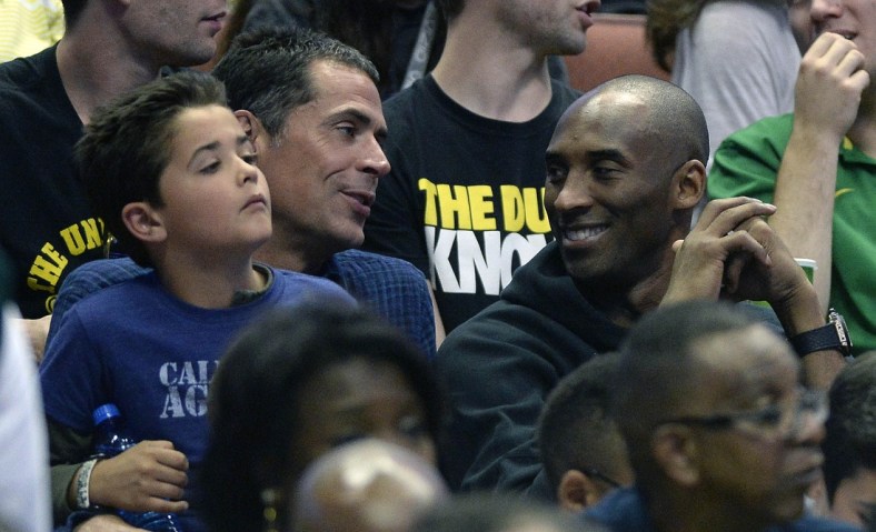Caption: March 26, 2016; Anaheim, CA, USA; Los Angeles Lakers player Kobe Bryant with agent Rob Pelinka in attendance as the Oregon Ducks play against Oklahoma Sooners during the second half of the West regional final of the NCAA Tournament at Honda Center. Mandatory Credit: Richard Mackson-USA TODAY Sports