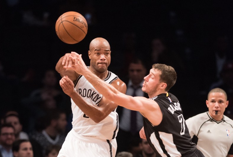Dec 16, 2015; Brooklyn, NY, USA; Brooklyn Nets guard Jarrett Jack (2) passes the ball while being defended by Miami Heat guard Goran Dragic (7) in the first half at Barclays Center. Mandatory Credit: William Hauser-USA TODAY Sports