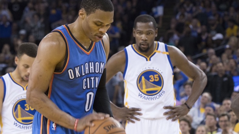 November 3, 2016; Oakland, CA, USA; Oklahoma City Thunder guard Russell Westbrook (0) shoots a technical foul shot as Golden State Warriors forward Kevin Durant (35) looks on during the second quarter at Oracle Arena. Mandatory Credit: Kyle Terada-USA TODAY Sports