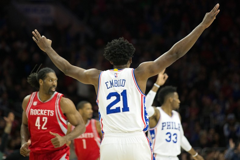 Jan 27, 2017; Philadelphia, PA, USA; Philadelphia 76ers center Joel Embiid (21) reacts to his three pointer in front of Houston Rockets center Nene Hilario (42) during the first quarter at Wells Fargo Center. Mandatory Credit: Bill Streicher-USA TODAY Sports
