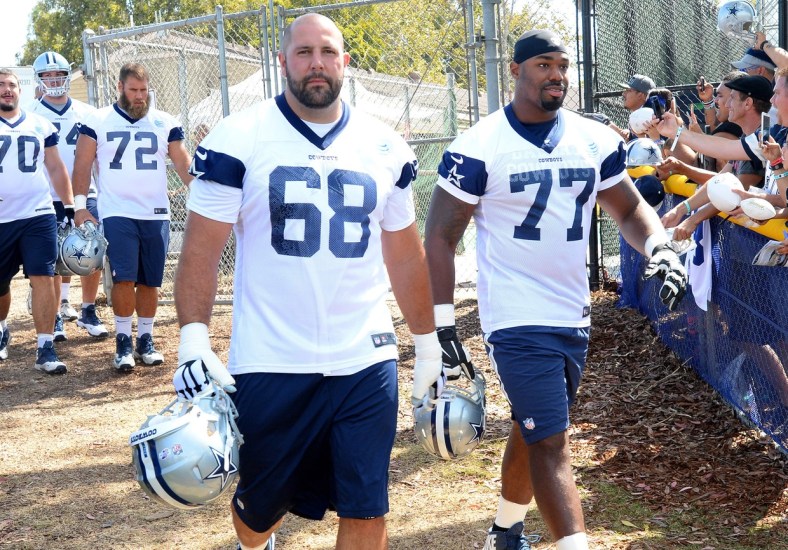 Caption: Jul 30, 2015; Oxnard, CA, USA; Dallas Cowboys tackle Doug Free (68) and tackle Tyron Smith (77) walk on to the field for the first day of training camp at River Ridge Fields. Mandatory Credit: Jayne Kamin-Oncea-USA TODAY Sports