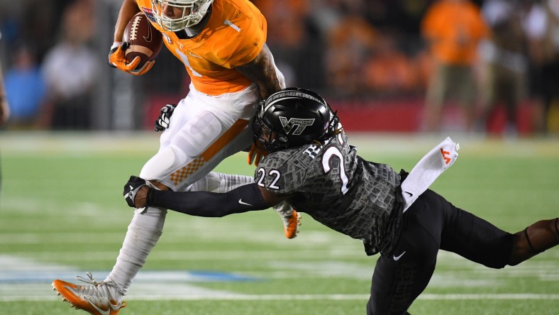 Caption: Sep 10, 2016; Bristol, TN, USA; Tennessee Volunteers running back Jalen Hurd (1) runs for a short gain while being tackled by Virginia Tech Hokies defensive back Terrell Edmunds (22) during the first half at Bristol Motor Speedway. Mandatory Credit: Christopher Hanewinckel-USA TODAY Sports Created: