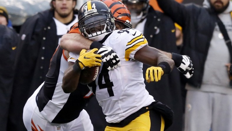 Dec 18, 2016; Cincinnati, OH, USA; Pittsburgh Steelers inside linebacker Lawrence Timmons (94) runs against Cincinnati Bengals tackle Andrew Whitworth (77) after intercepting a pass during the second half at Paul Brown Stadium. The Steelers won 24-20. Mandatory Credit: David Kohl-USA TODAY Sports