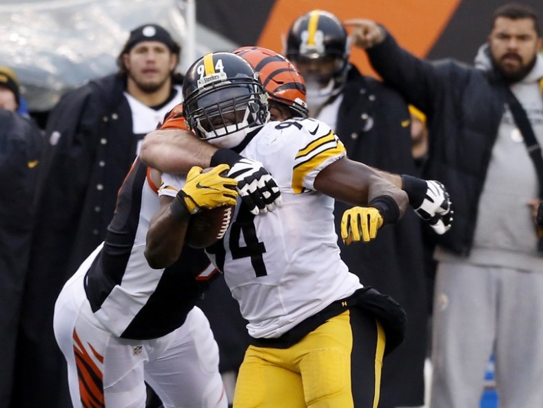 Dec 18, 2016; Cincinnati, OH, USA; Pittsburgh Steelers inside linebacker Lawrence Timmons (94) runs against Cincinnati Bengals tackle Andrew Whitworth (77) after intercepting a pass during the second half at Paul Brown Stadium. The Steelers won 24-20. Mandatory Credit: David Kohl-USA TODAY Sports
