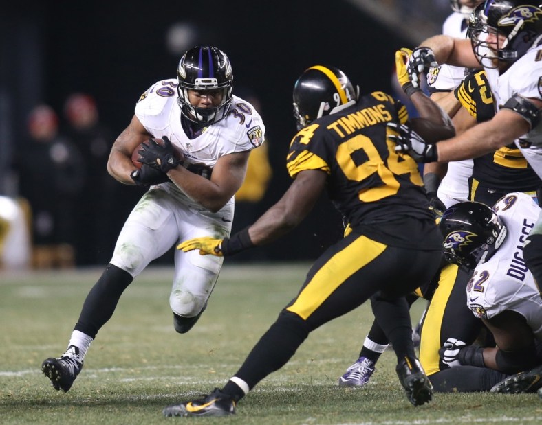 Dec 25, 2016; Pittsburgh, PA, USA; Baltimore Ravens running back Kenneth Dixon (30) rushes the ball against Pittsburgh Steelers inside linebacker Lawrence Timmons (94) during the fourth quarter at Heinz Field. The Steelers won 31-27. Mandatory Credit: Charles LeClaire-USA TODAY Sports