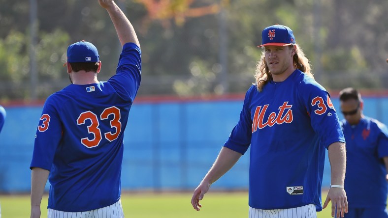 Feb 14, 2017; Port St. Lucie, FL, USA; New York Mets starting pitcher Matt Harvey (33) and starting pitcher Noah Syndergaard (34) stretch during spring training workouts at Tradition Field. Mandatory Credit: Jasen Vinlove-USA TODAY Sports