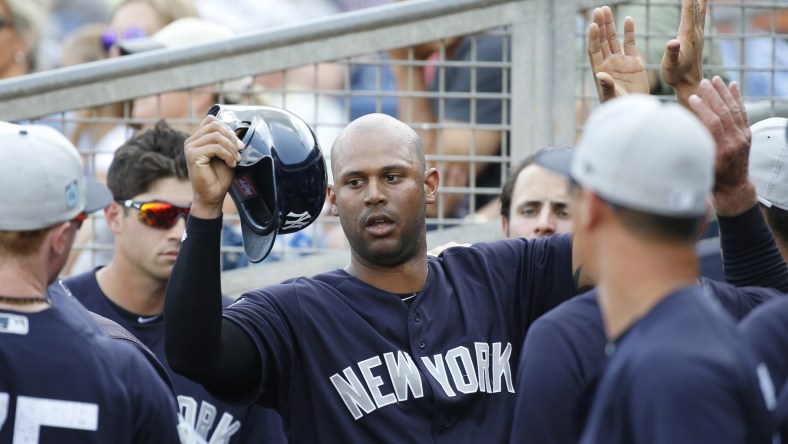 Yankees right fielder Aaron Hicks is congratulated in the dugout