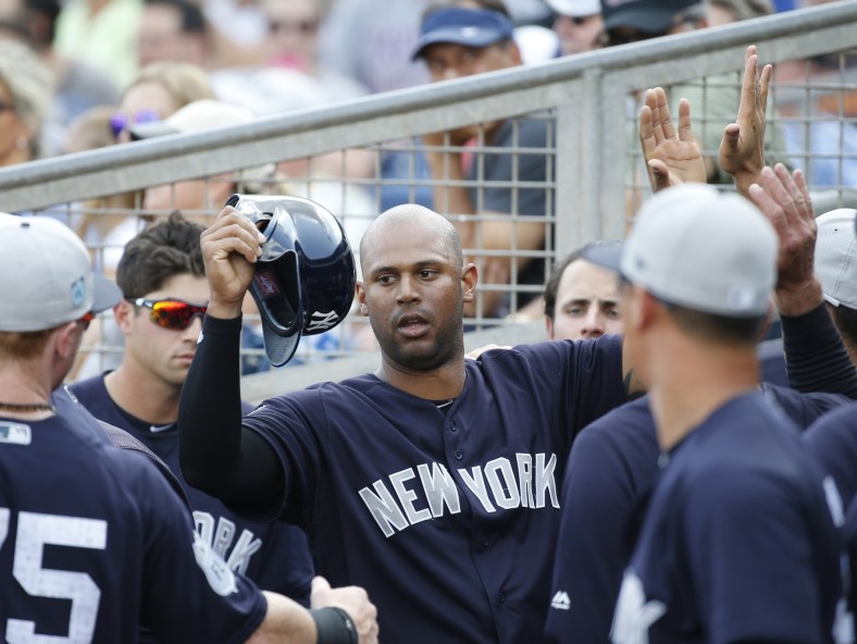 Yankees right fielder Aaron Hicks is congratulated in the dugout