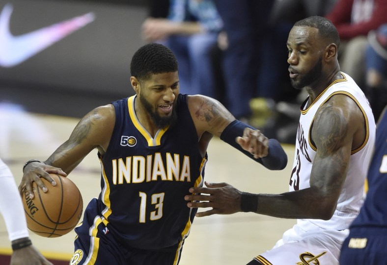 Caption: Apr 2, 2017; Cleveland, OH, USA; Indiana Pacers forward Paul George (13) drives against Cleveland Cavaliers forward LeBron James (23) in the second quarter at Quicken Loans Arena. Mandatory Credit: David Richard-USA TODAY Sports