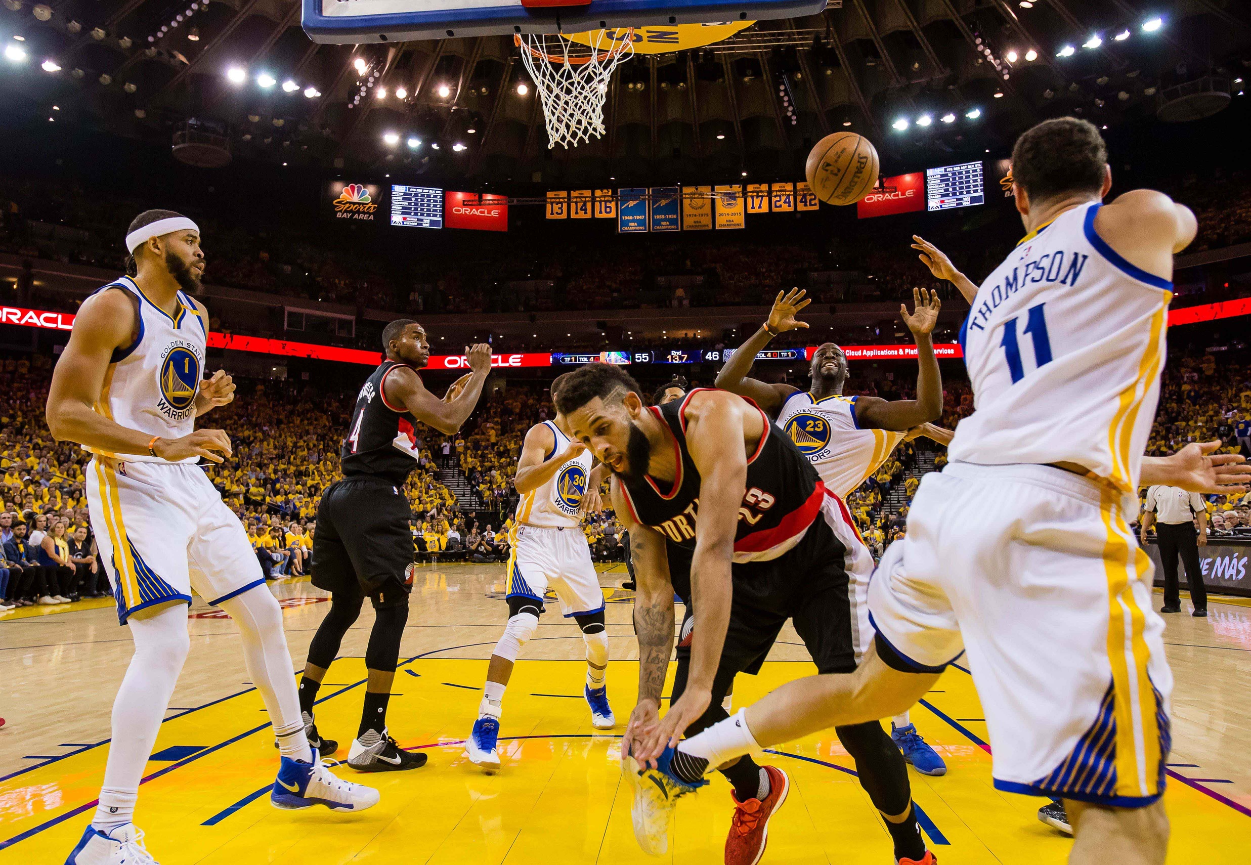 Apr 19, 2017; Oakland, CA, USA; Golden State Warriors guard Klay Thompson (11) passes the pass to forward Draymond Green (23) against Portland Trail Blazers guard Allen Crabbe (23) during the second quarter in game two of the first round of the 2017 NBA Playoffs at Oracle Arena. The Golden State Warriors defeated the Portland Trail Blazers 110-81. Mandatory Credit: Kelley L Cox-USA TODAY Sports