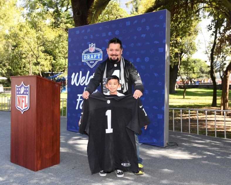 Caption: Nov 21, 2016; Mexico City, MEX; A youngster poses with Oakland Raiders jersey at Draft Day exhibit during the NFL Fan Fest at Chapultepec Park prior to the NFL International Series game between the Houston Texans and the Oakland Raiders. Mandatory Credit: Kirby Lee-USA TODAY Sports Created: