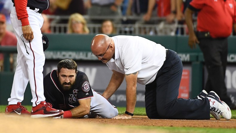 pr 28, 2017; Washington, DC, USA; Washington Nationals center fielder Adam Eaton (2) is looked at by a trainer after suffering an apparent leg injury during the ninth inning against the New York Mets at Nationals Park. Mandatory Credit: Brad Mills-USA TODAY Sports