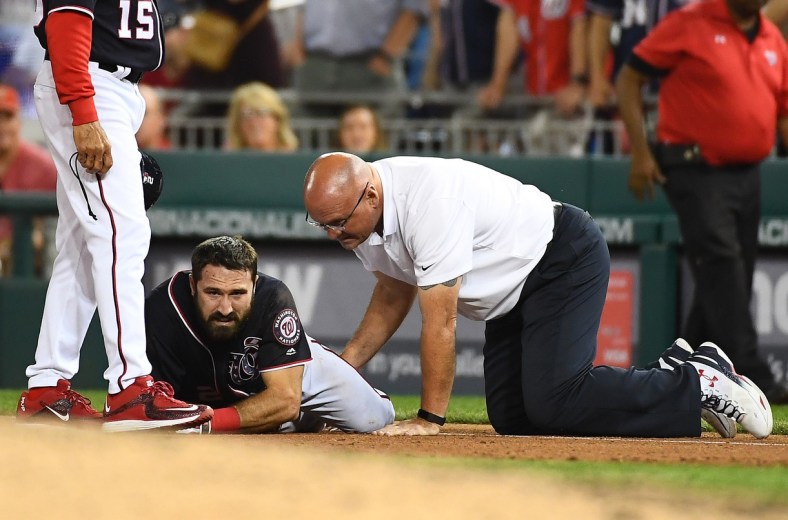 pr 28, 2017; Washington, DC, USA; Washington Nationals center fielder Adam Eaton (2) is looked at by a trainer after suffering an apparent leg injury during the ninth inning against the New York Mets at Nationals Park. Mandatory Credit: Brad Mills-USA TODAY Sports