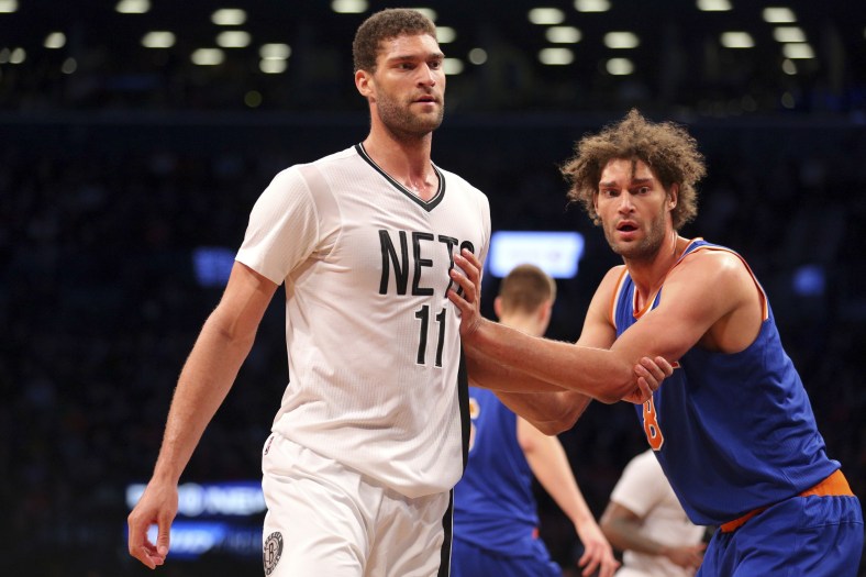 Feb 19, 2016; Brooklyn, NY, USA; New York Knicks center Robin Lopez (8) guards his brother Brooklyn Nets center Brook Lopez (11) during the fourth quarter at Barclays Center. The Nets defeated the Knicks 109-98. Mandatory Credit: Brad Penner-USA TODAY Sports