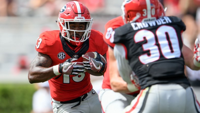 Apr 22, 2017; Athens, GA, USA; Georgia Bulldogs red team running back Elijah Holyfield (13) runs against black team linebacker Tae Crowder (30) during the second half during the Georgia Spring Game at Sanford Stadium. Red defeated Black 25-22. Mandatory Credit: Dale Zanine-USA TODAY Sports