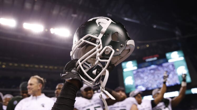 Dec 5, 2015; Indianapolis, IN, USA; A helmet is raised in celebration after the Michigan State Spartans defeated the Iowa Hawkeyes in the Big Ten Conference football championship game at Lucas Oil Stadium. Mandatory Credit: Brian Spurlock-USA TODAY Sports