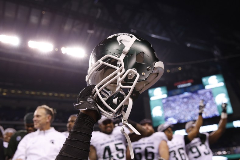 Dec 5, 2015; Indianapolis, IN, USA; A helmet is raised in celebration after the Michigan State Spartans defeated the Iowa Hawkeyes in the Big Ten Conference football championship game at Lucas Oil Stadium. Mandatory Credit: Brian Spurlock-USA TODAY Sports