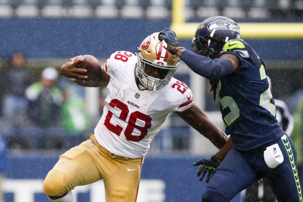 NFL San Francisco 49ers running back Carlos Hyde gets around Seattle Seahawks cornerback Richard Sherman
