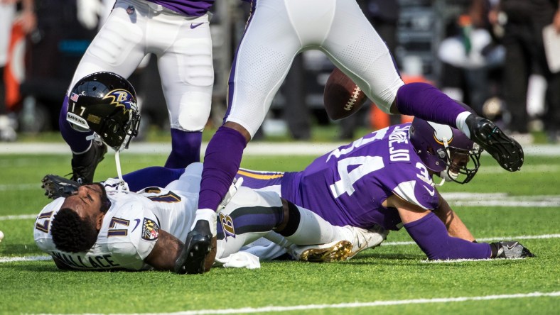 Vikings safety Andrew Sendejo hits Ravens receiver Mike Wallace