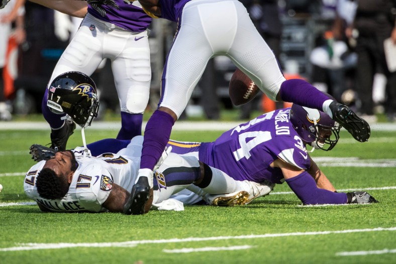 Vikings safety Andrew Sendejo hits Ravens receiver Mike Wallace
