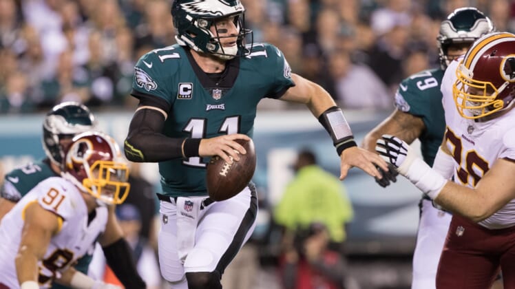 NFL Philadelphia Eagles quarterback Carson Wentz (11) runs out of the pocket past Washington Redskins defensive tackle Matthew Ioannidis (98) during the first quarter at Lincoln Financial Field.