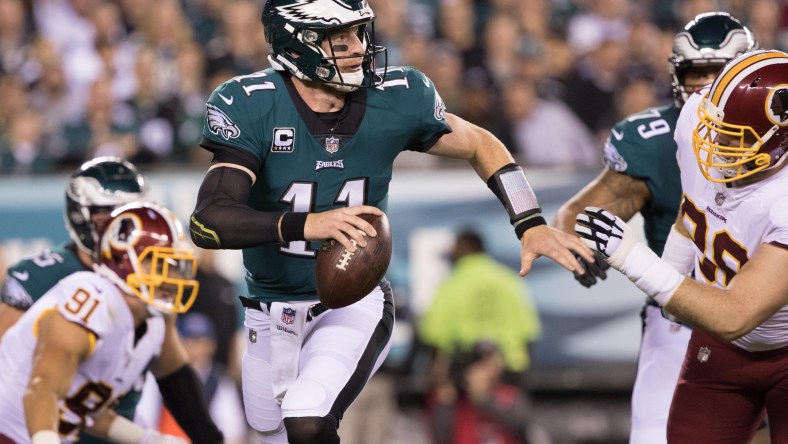 NFL Philadelphia Eagles quarterback Carson Wentz (11) runs out of the pocket past Washington Redskins defensive tackle Matthew Ioannidis (98) during the first quarter at Lincoln Financial Field.