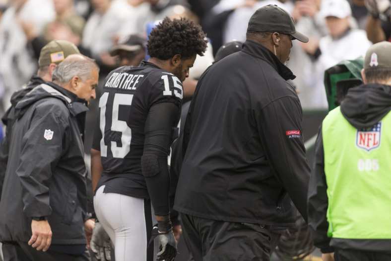 Raiders receiver Michael Crabtree being escorted off field