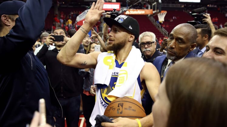 May 28, 2018; Houston, TX, USA; Golden State Warriors guard Stephen Curry (30) high fives a fan after defeating the Houston Rockets in game seven of the Western conference finals of the 2018 NBA Playoffs at Toyota Center. Mandatory Credit: Troy Taormina-USA TODAY Sports