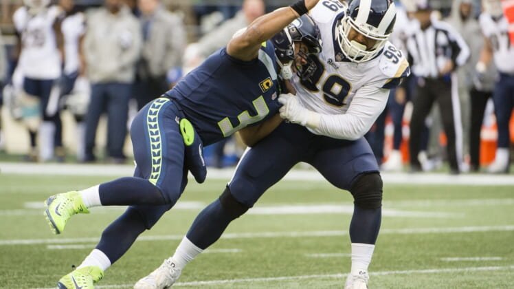 Los Angeles Rams defensive tackle Aaron Donald sacks Settle Seahawks quarterback Russell Wilson