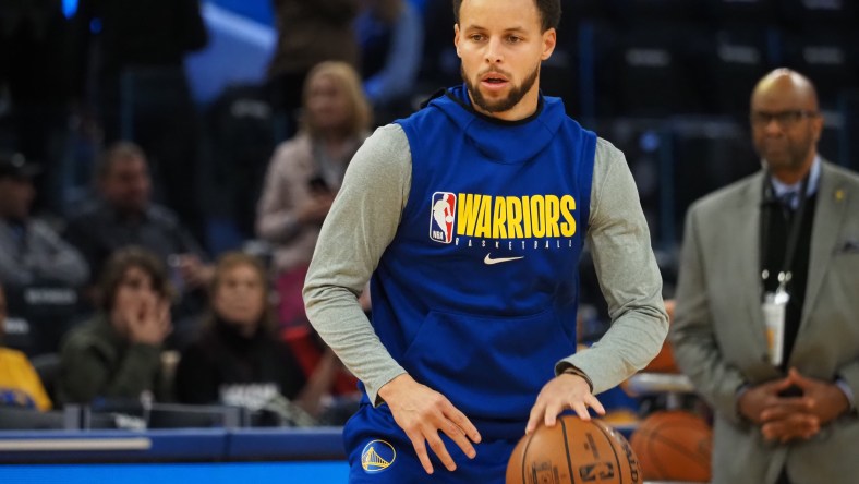 Warriors' Stephen Curry warms up before game against the Heat.
