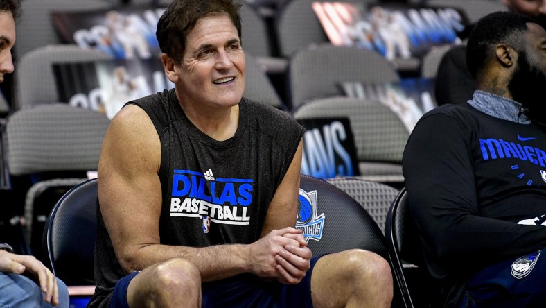 Dallas Mavericks owner Mark Cuban sits on the bench